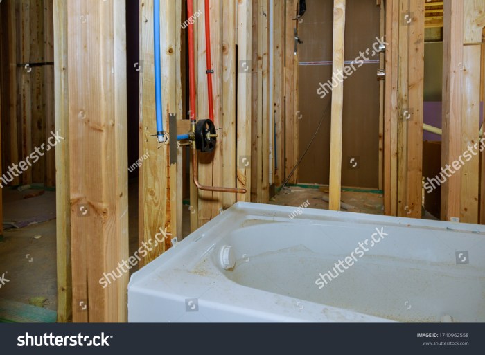 Unfinished bathroom with wall-mounted fixtures